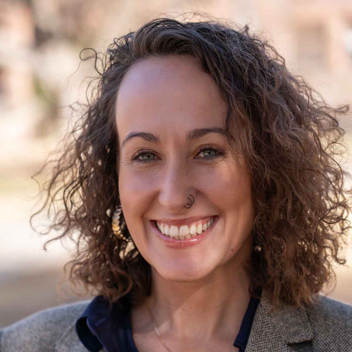 Headshot of Kelbi Delaune, Ph.D. standing outdoors.