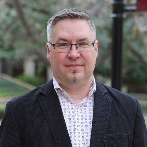 Dr. Robert Mace standing outdoors.