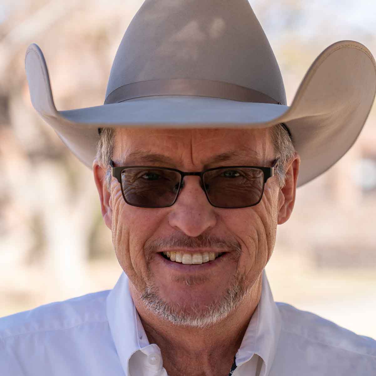Headshot portrait of Billy Tarrant standing outdoors.