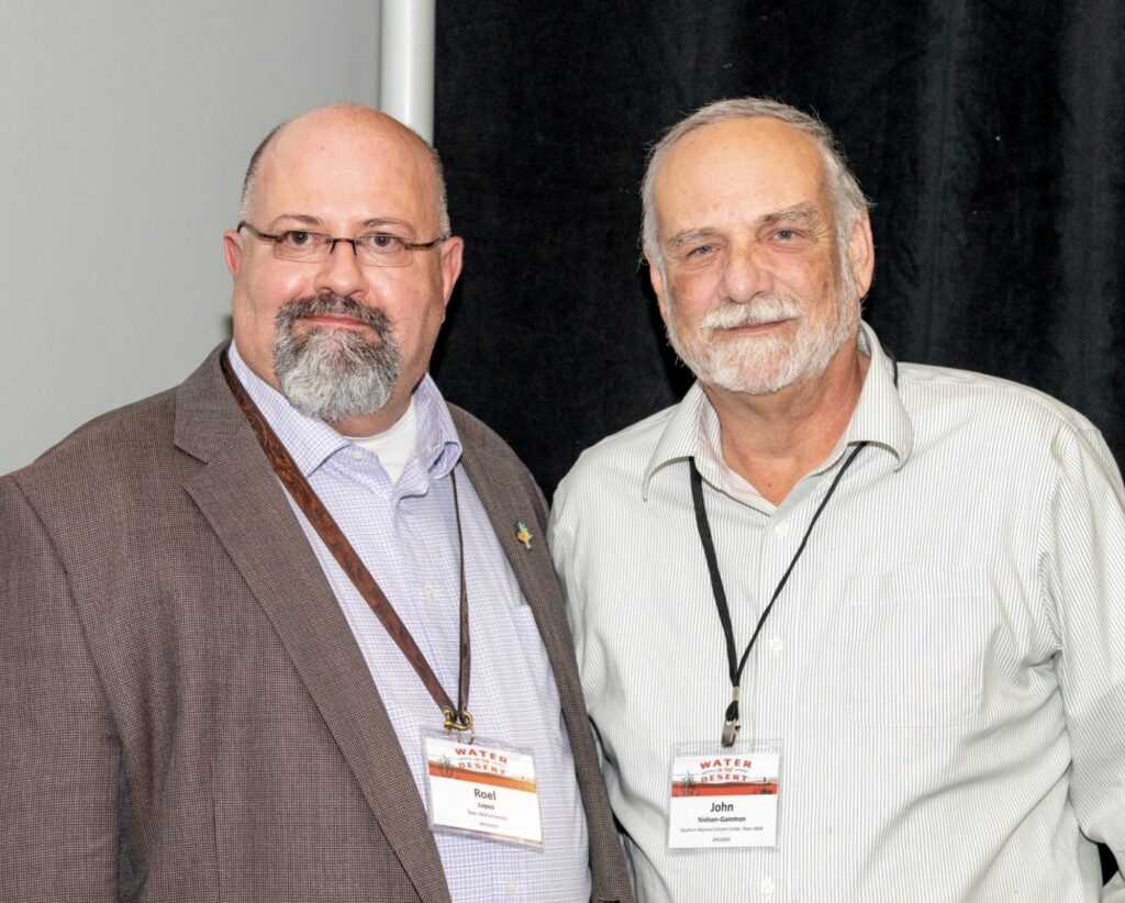 Dr. Roel Lopez at the conference with a fellow attendee.