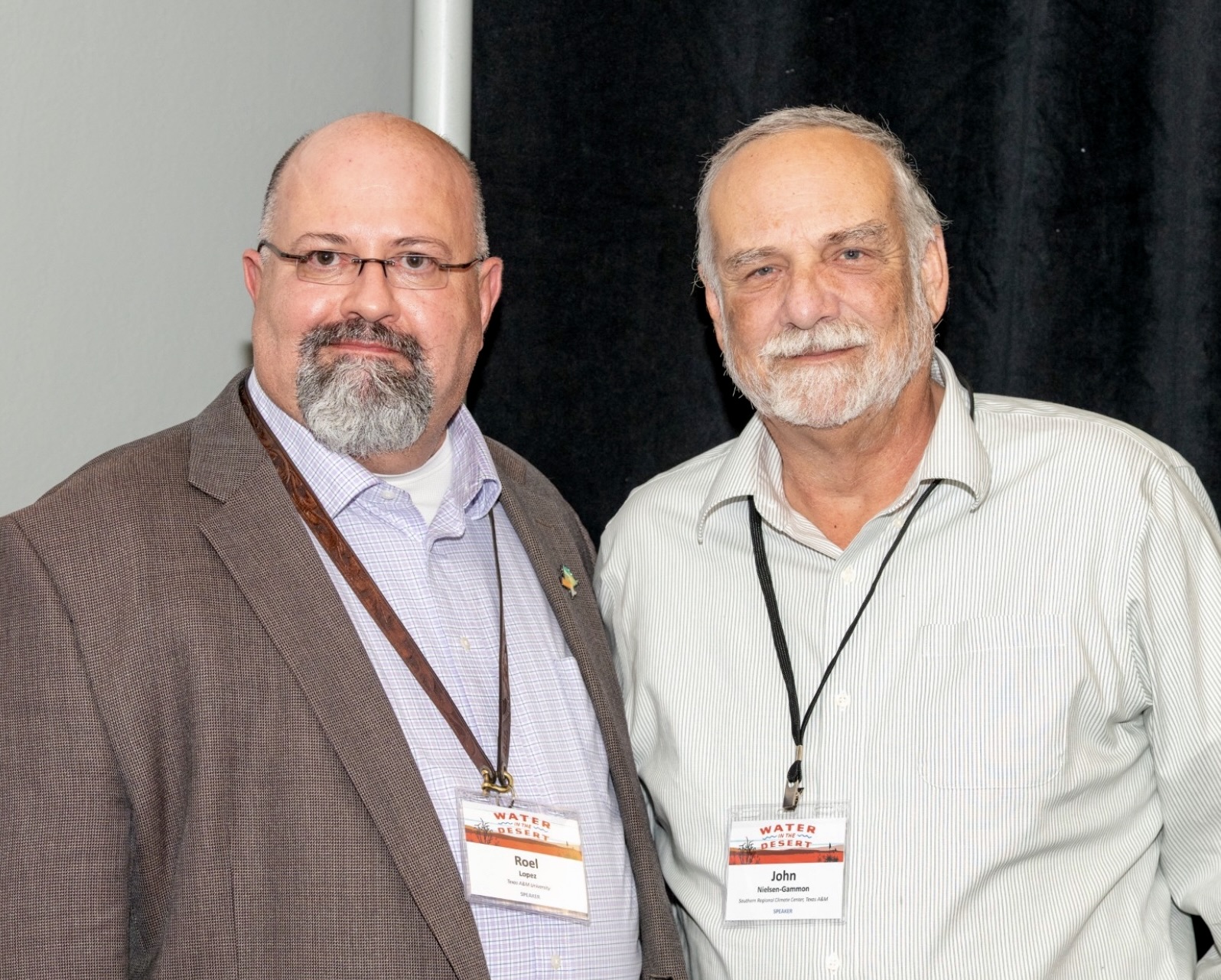 Dr. Roel Lopez at the conference with a fellow attendee.
